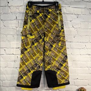 SPYDER Boys' Propulsion ski pants with an olive, black, and yellow plaid pattern